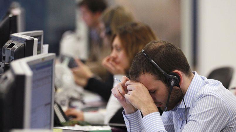 A worker on the IG Group's trading floor looks away from his screens in the City of London A worker on the IG Group's trading floor looks away from his screens in the City of London