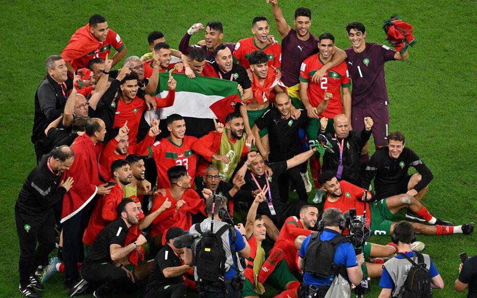 World Cup.  Moroccan players wave the Palestinian flag after their success