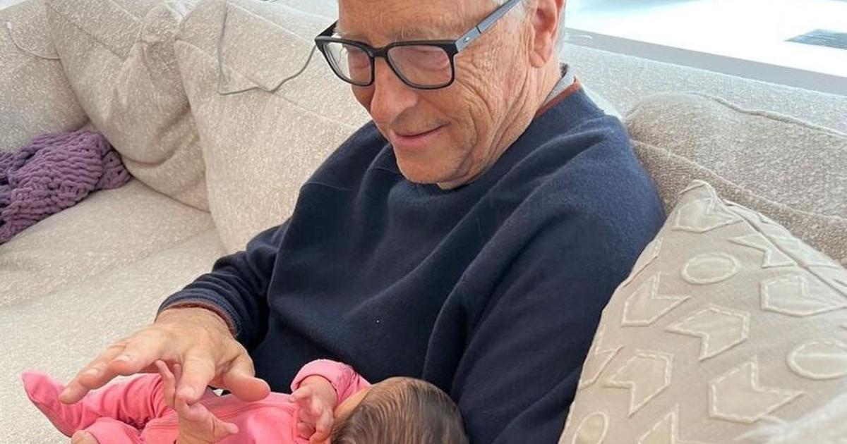 Photos of Melinda and Bill Gates holding their first granddaughter