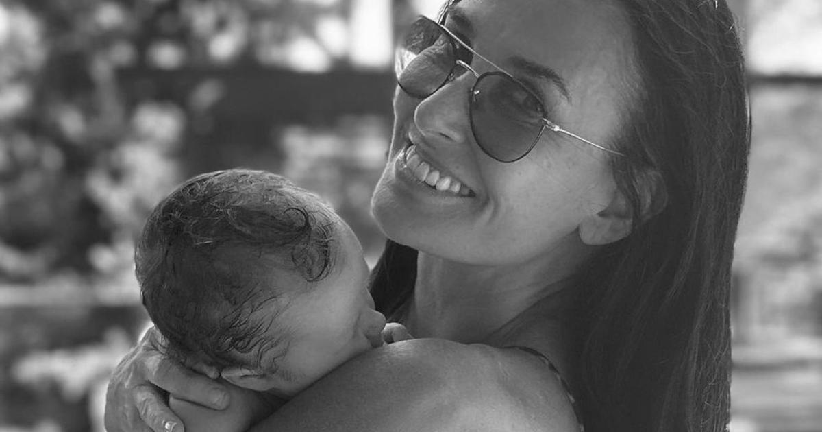 Demi Moore was photographed in a leopard bikini with her 1-month-old granddaughter in her arms.