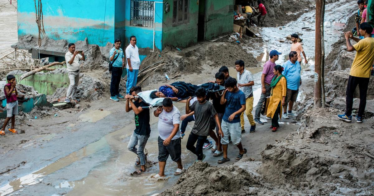 at least 77 people died after a lake overflowed in the Himalayas