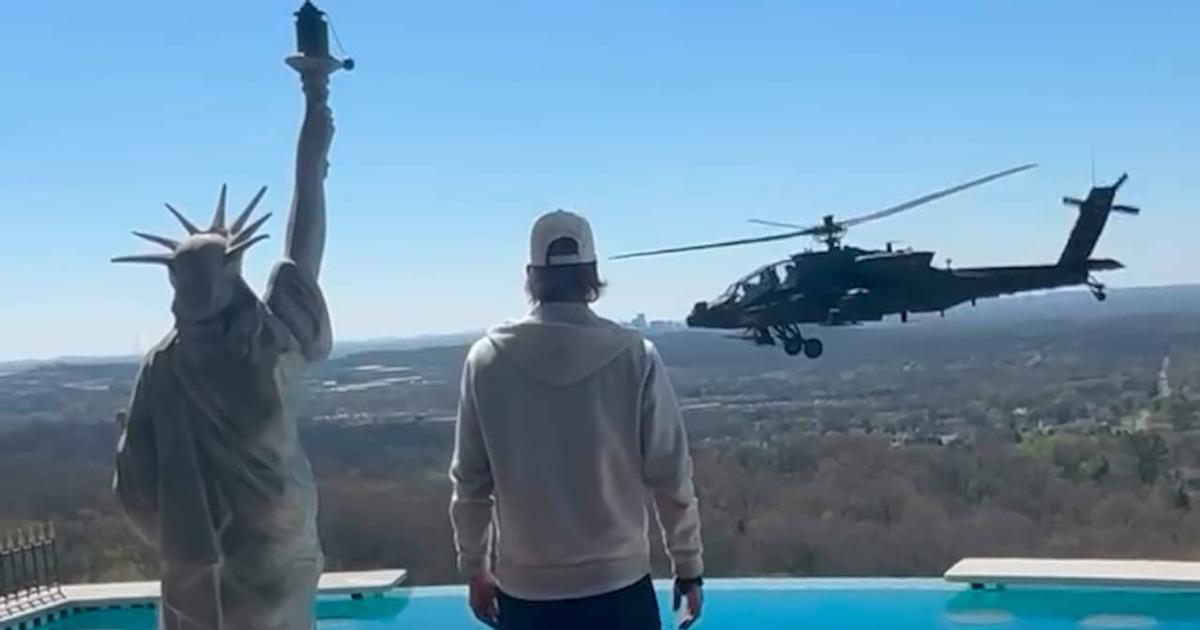 Donald Trump salutes the impromptu parade of two helicopters above Kid Rock’s mansion