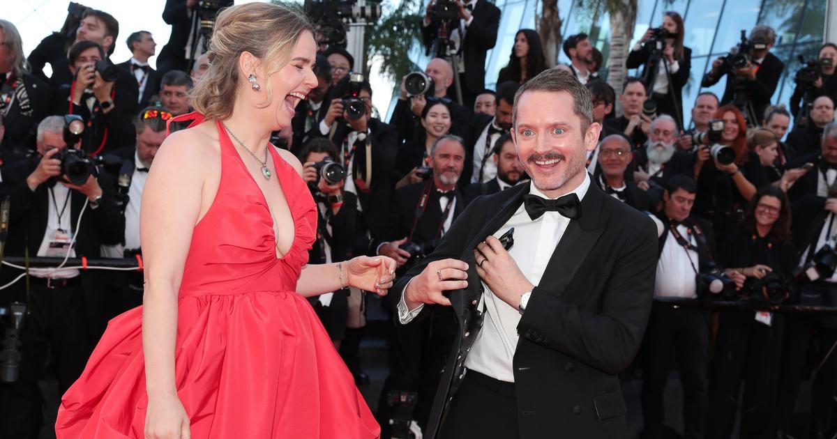Hand in hand, Elijah Wood and his companion spread joy in the kingdom of Cannes