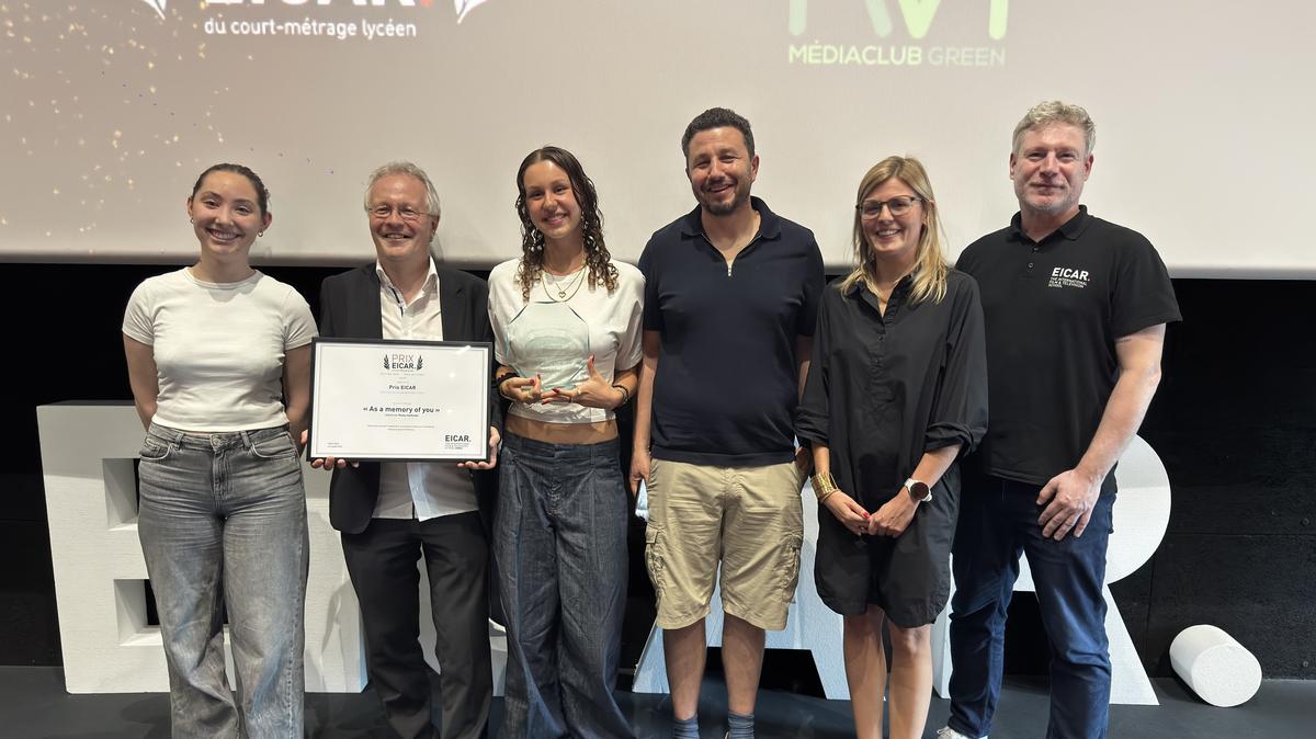 Remise du Prix EICAR du Court-Métrage Lycéen 2026 sur la scène de la salle de cinéma d'EICAR : six personnes posent, la lauréate tenant son trophée à côté du diplôme « As a Memory of You »