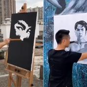 Un artiste de rue chinois peint à l'aide de ses nunchakus