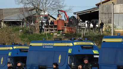 Des gendarmes surveillent l’enlèvement du cadavre d’une vache dans une ferme touchée par la dermatose, à Les-Bordes-sur-Arize, dans le département de l’Ariège, dans le sud-ouest de la France, le 12 décembre 2025.