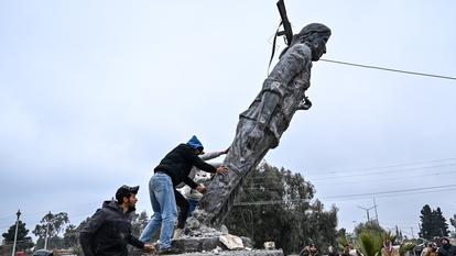 Des habitants renversent la statue d’une combattante kurde après la prise de contrôle de la ville par les forces gouvernementales syriennes, le 18 janvier 2026.