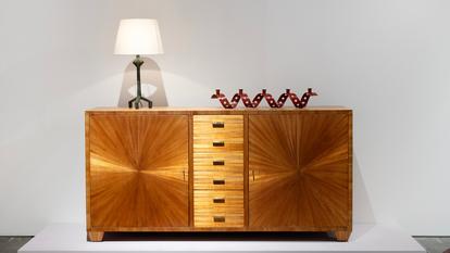Commode Jean-Michel Frank (circa 1930), sycomore, marqueterie de paille et bronze doré, estimation entre 400 000 et 600 000 dollars. Bougeoir Jean Royère (20 000-30 000 euros).