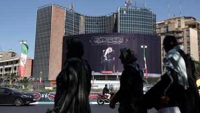 Des piétons passent dans une rue de Téhéran en face d’une représentation montrant l’ayatollah Ali Khamenei, ancien guide suprême éliminé par une frappe israélo-américaine.