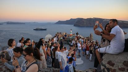 Les touristes restent nombreux à Santorin, ici à Oia pour le coucher de soleil, le 23 juin dernier, mais bien moins qu’avant.