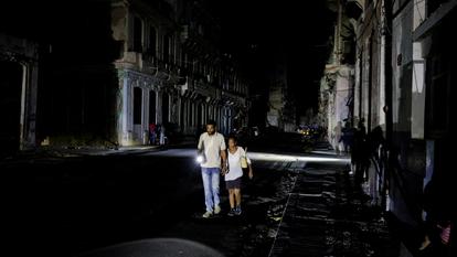 Des gens marchent dans une rue alors que le réseau électrique national de Cuba s’est effondré, marquant la troisième panne majeure en neuf jours, à La Havane, Cuba, le 14 juillet 2026.