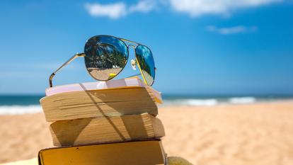 Books and sunglasses on a beach