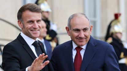 France's President Emmanuel Macron and Armenia's Prime Minister Nikol Pachinian react after a meeting at The Elysee Presidential Palace in Paris on October 30, 2025, on the sidelines of the Paris Peace Forum. (Photo by Ludovic MARIN / AFP)