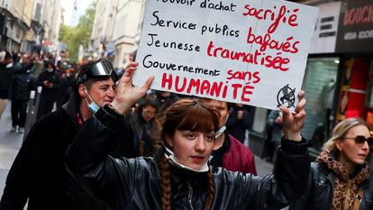 Une femme brandit une pancarte lors d’une manifestation interdite.