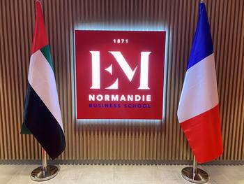 UAE and French flags are displayed at the campus reception. 
