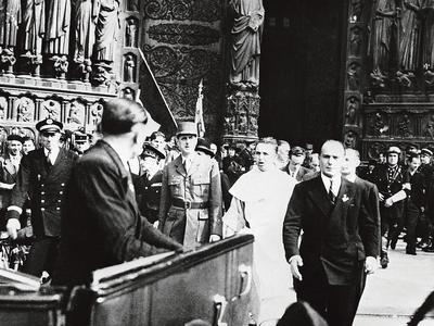 Accompagné du dominicain Raymond Léopold Bruckberger, le général de Gaulle sort de Notre-Dame, où une messe à été célébrée à l’occasion de la Libération de Paris, le 26 août 1944 .