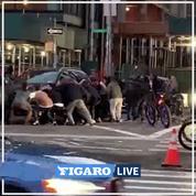Des passants aident une personne coincée sous une voiture à New York