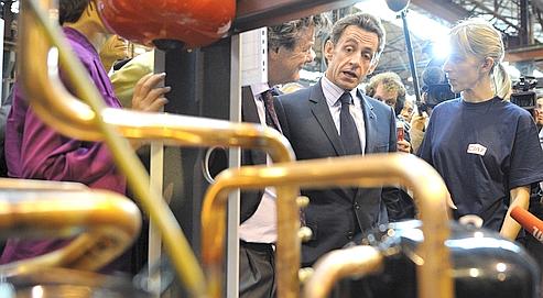 Le président de la République et son ministre de l'Ecologie, Jean-Louis Borloo, en visite à l'usine Ciat à Culoz, en septembre 2009.