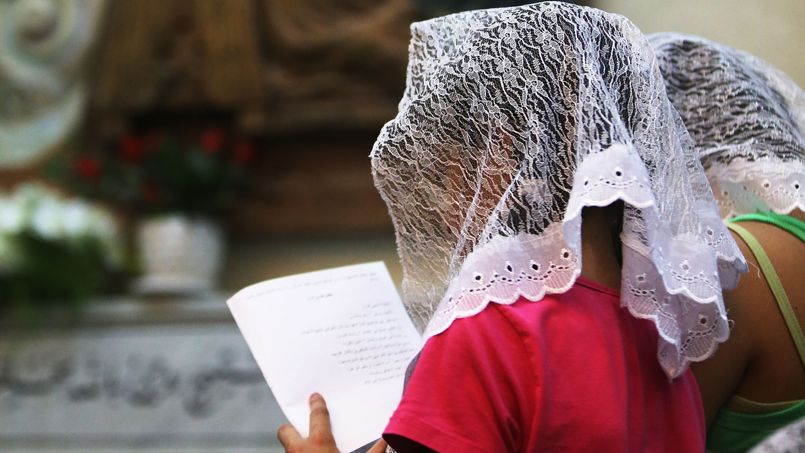 Le 30 juillet 2014, des chrétiens d'Orient prient pour la paix en Irak, en Lybie, en Syrie et à Gaza, dans une église d'Amman, en Jordanie.