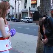 Une jeune fille examine les testicules des passants dans la rue